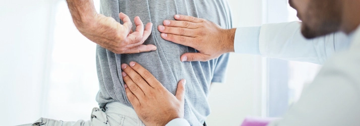 Chiropractic Nashville TN Back Exam Man Back evaluation being conducted by a chiropractor.