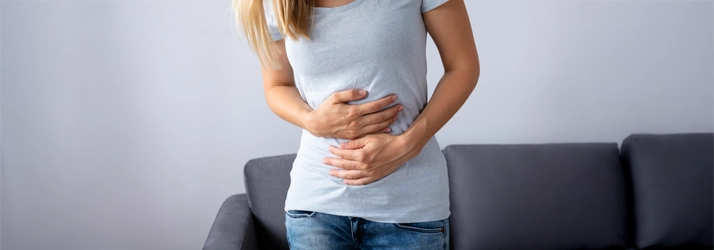 Chiropractic Nashville TN Gut Issues Person holding their stomach in pain.
