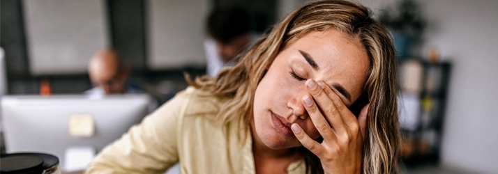 Chiropractic Nashville TN Woman Stressed Stressed woman holding her forehead.